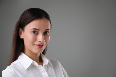 Photo of Portrait of confident businesswoman on grey background. Space for text