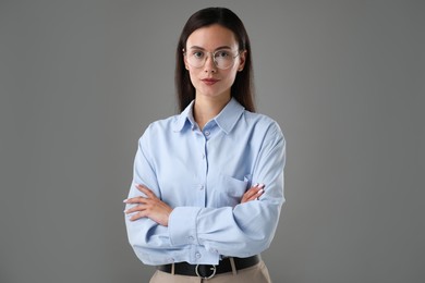 Photo of Portrait of confident businesswoman on grey background