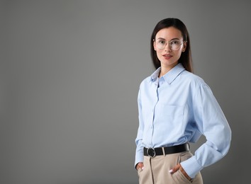 Photo of Portrait of confident businesswoman on grey background. Space for text