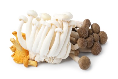 Photo of Pile of different raw mushrooms isolated on white