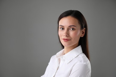 Photo of Portrait of confident businesswoman on grey background. Space for text