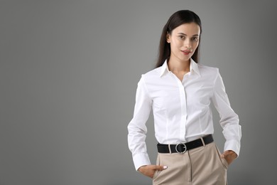 Photo of Portrait of confident businesswoman on grey background. Space for text