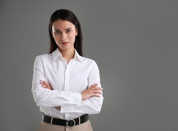 Photo of Portrait of confident businesswoman on grey background. Space for text