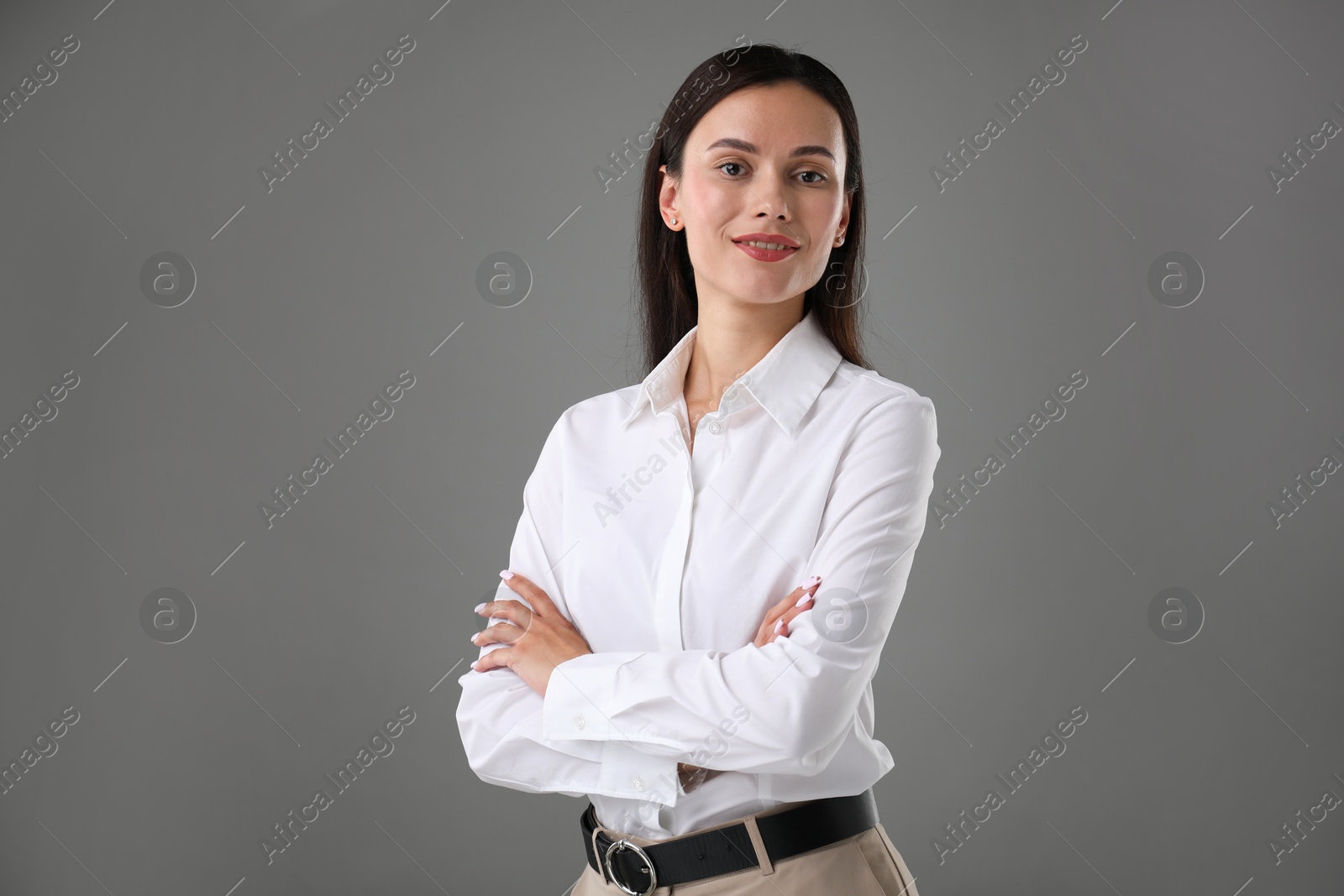 Photo of Portrait of confident businesswoman on grey background. Space for text