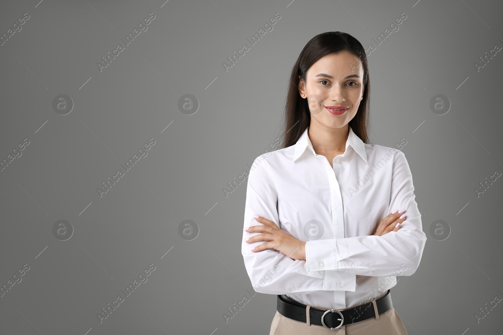 Photo of Portrait of confident businesswoman on grey background. Space for text