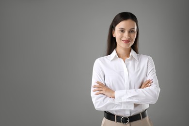 Photo of Portrait of confident businesswoman on grey background. Space for text