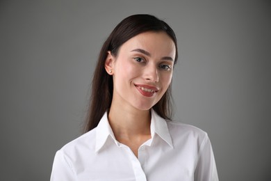 Photo of Portrait of confident businesswoman on grey background