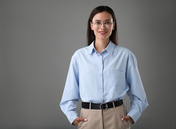 Photo of Portrait of confident businesswoman on grey background. Space for text