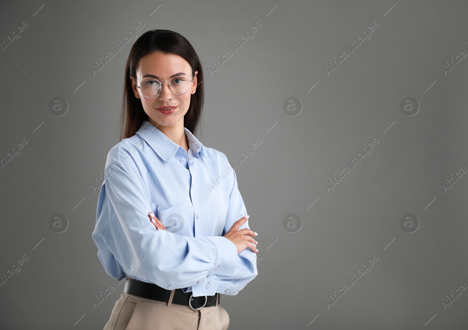 Photo of Portrait of confident businesswoman on grey background. Space for text