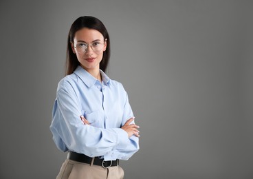 Photo of Portrait of confident businesswoman on grey background. Space for text