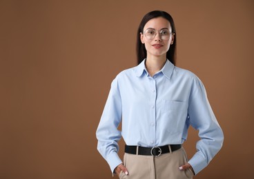 Photo of Portrait of confident businesswoman on brown background. Space for text