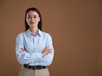 Photo of Portrait of confident businesswoman on brown background. Space for text