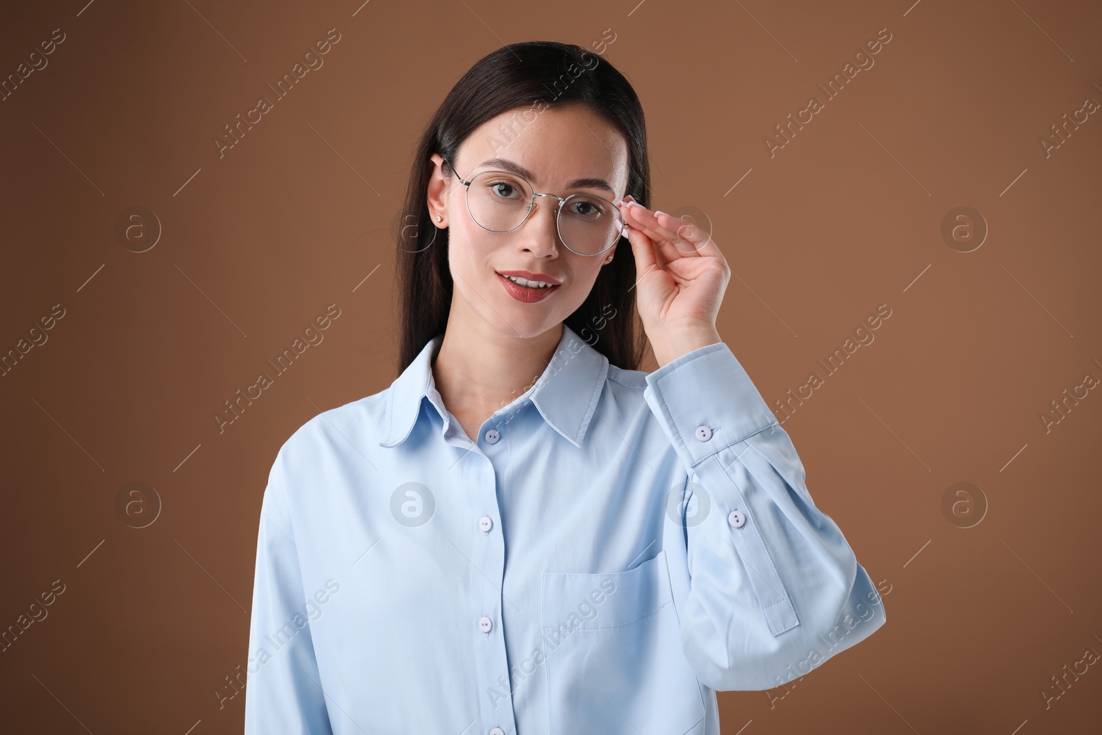 Photo of Portrait of confident businesswoman on brown background