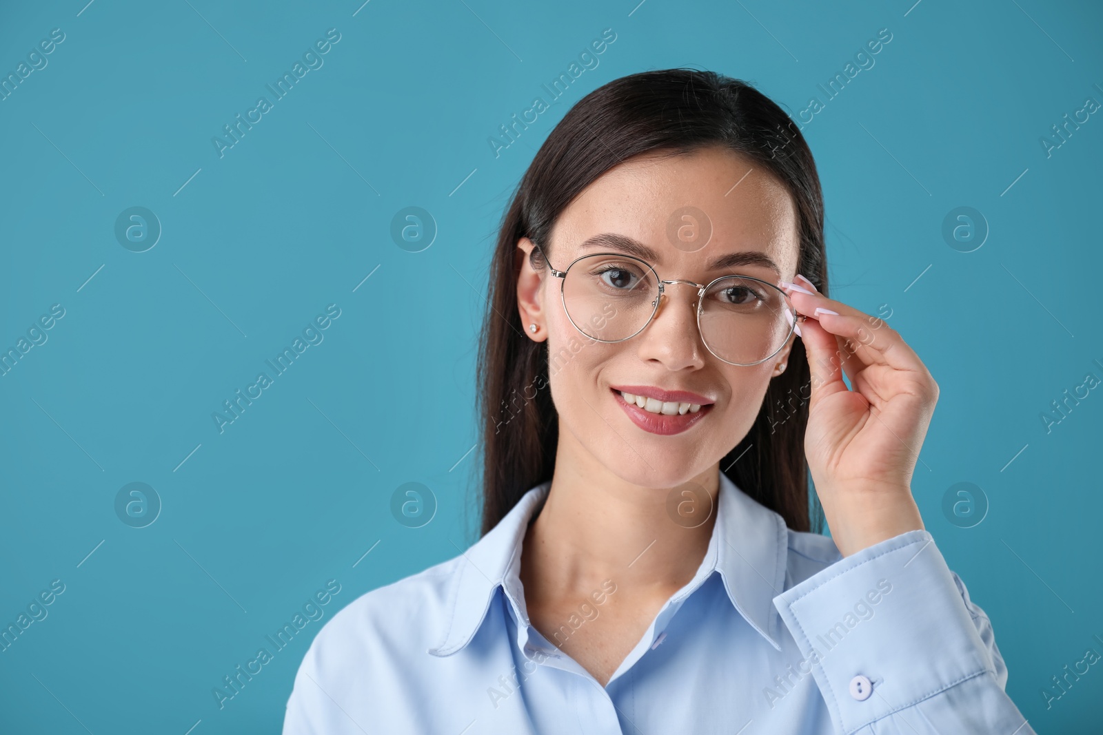 Photo of Portrait of confident businesswoman on blue background. Space for text