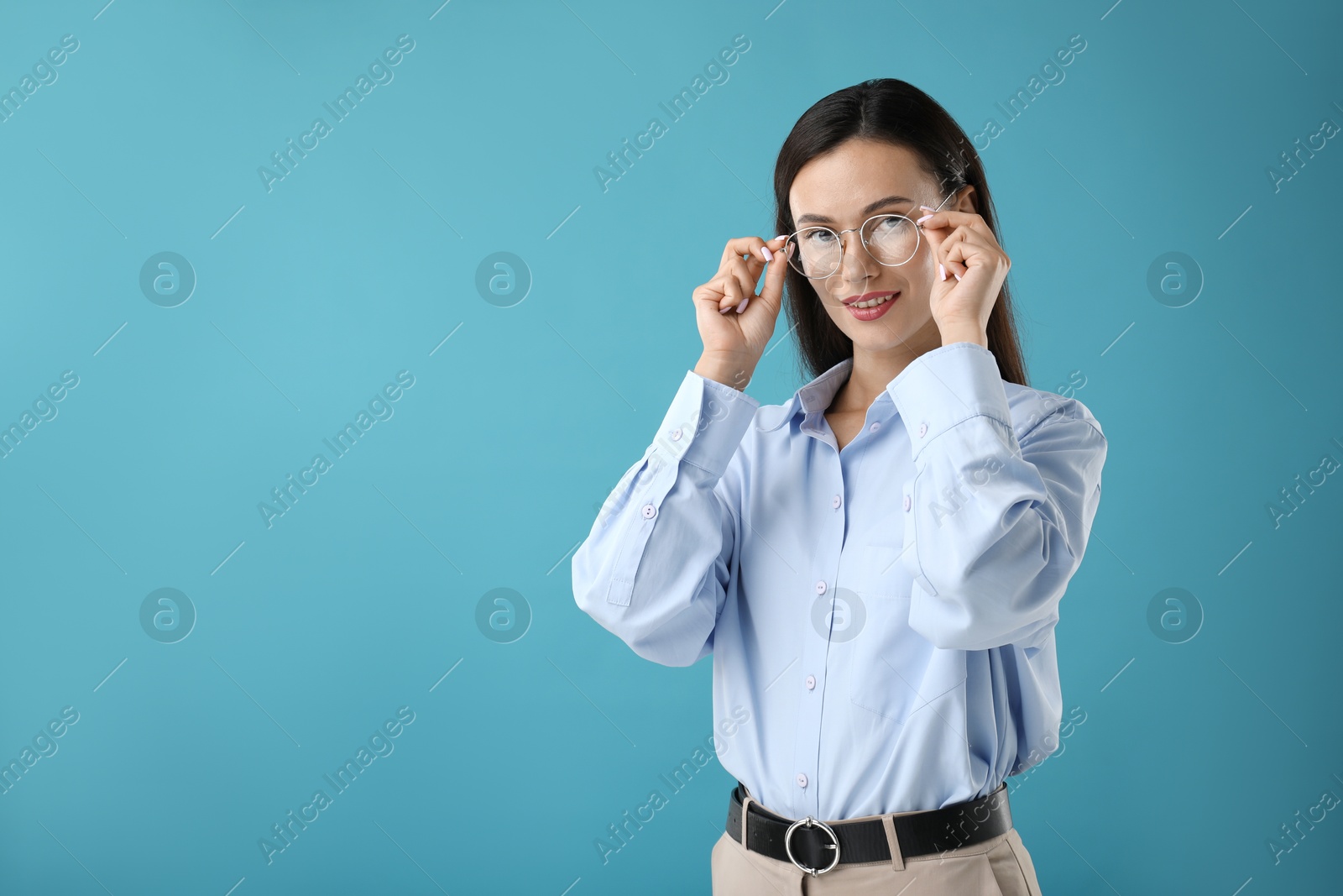 Photo of Portrait of confident businesswoman on blue background. Space for text