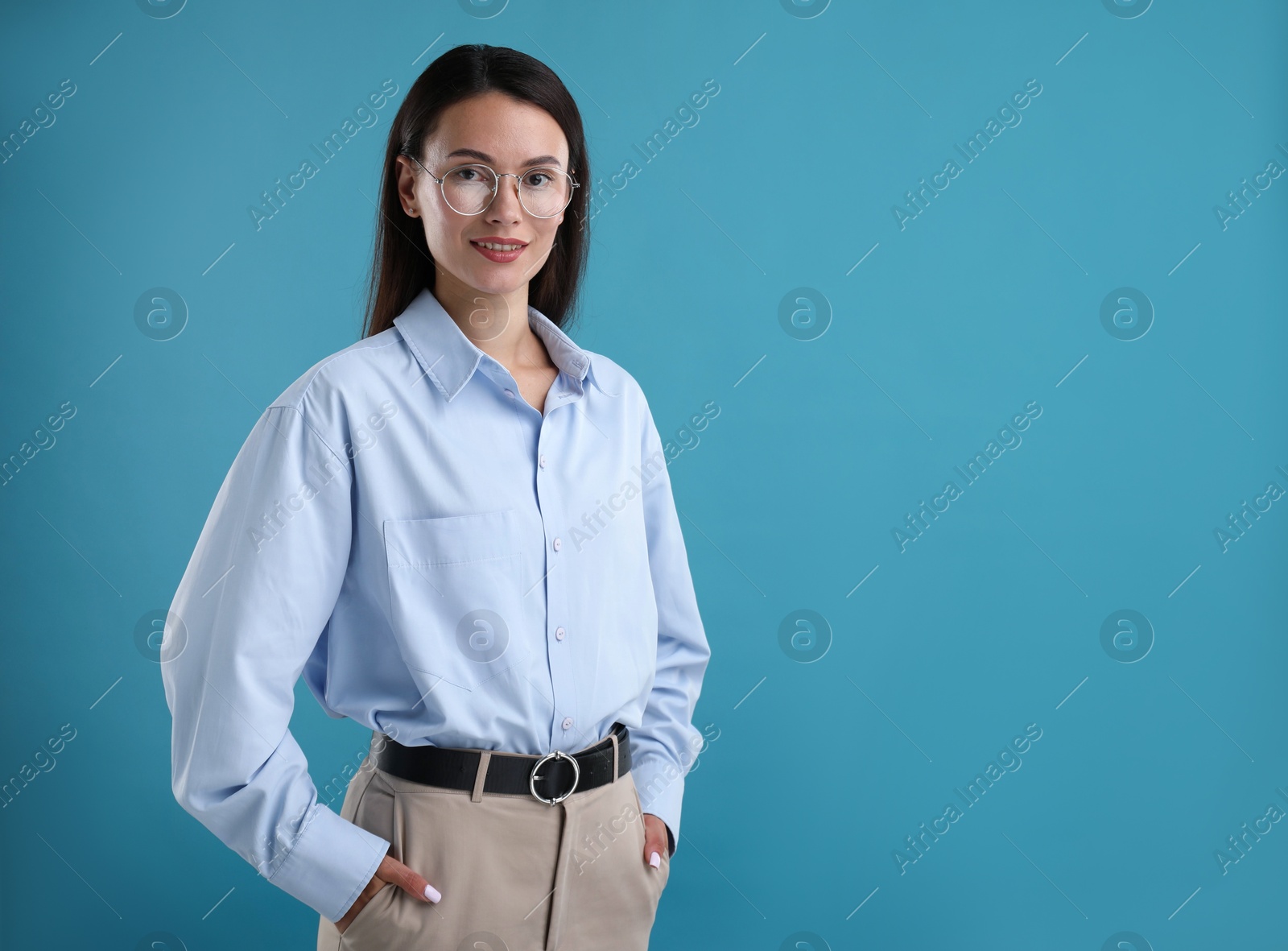 Photo of Portrait of confident businesswoman on blue background. Space for text