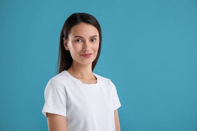 Photo of Portrait of beautiful woman on blue background. Space for text