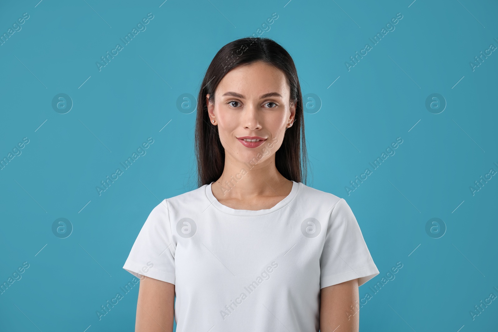 Portrait of beautiful woman on blue background Photo of Portrait of beautiful woman on blue background