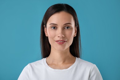 Photo of Portrait of beautiful woman on blue background