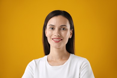 Photo of Portrait of beautiful woman on yellow background