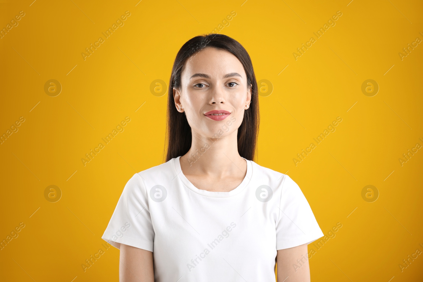 Photo of Portrait of beautiful woman on yellow background