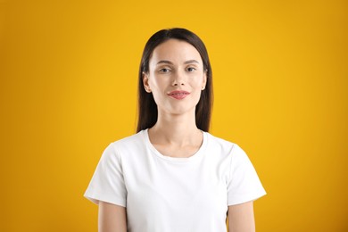 Photo of Portrait of beautiful woman on yellow background