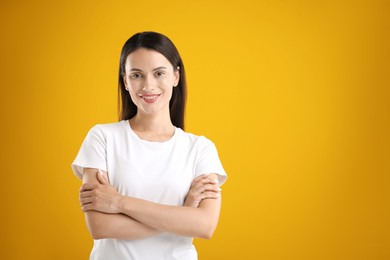 Photo of Portrait of beautiful woman on yellow background. Space for text