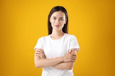 Photo of Portrait of beautiful woman on yellow background