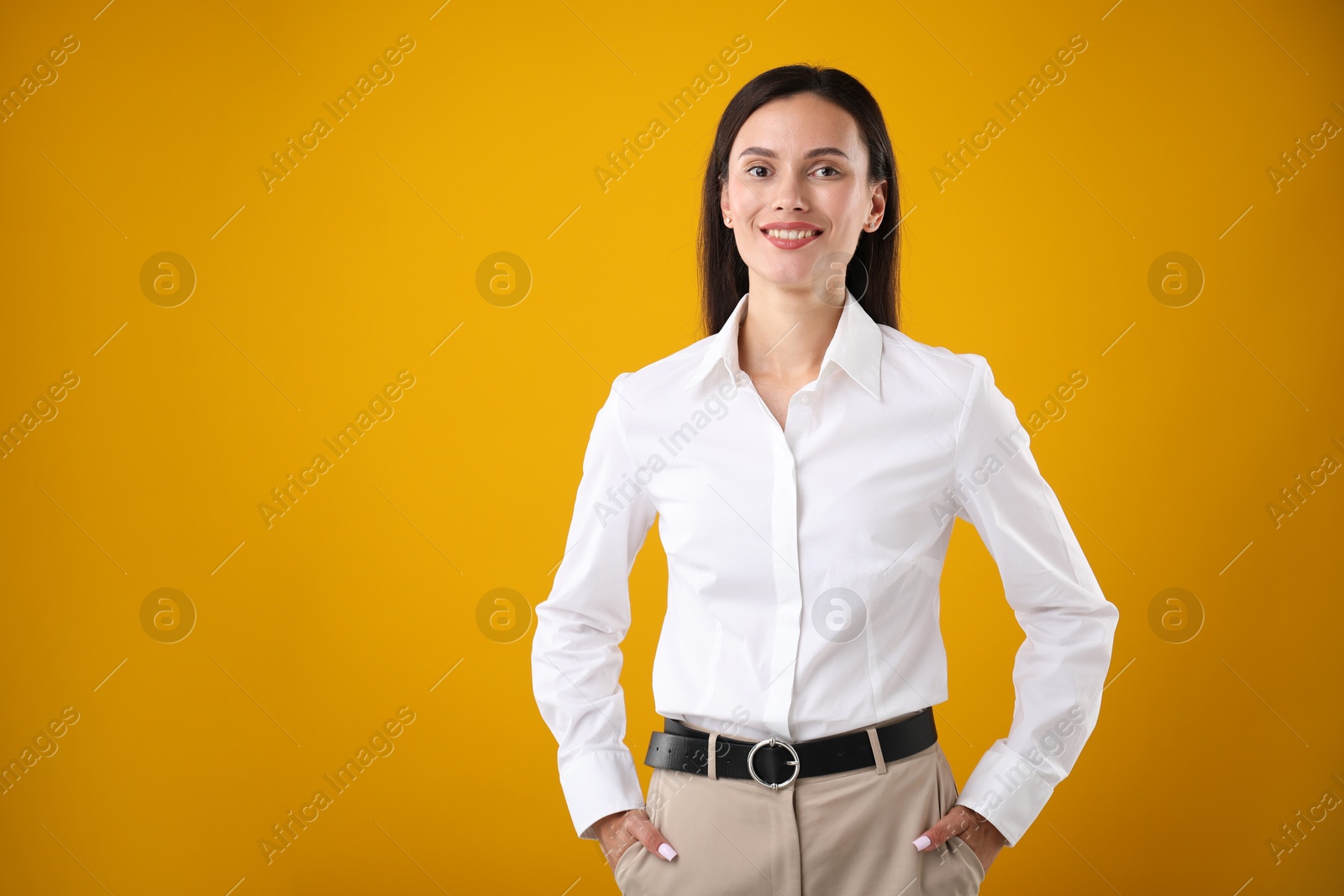 Portrait of confident businesswoman on yellow background. Space for text Photo of Portrait of confident businesswoman on yellow background. Space for text