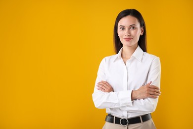 Photo of Portrait of confident businesswoman on yellow background. Space for text