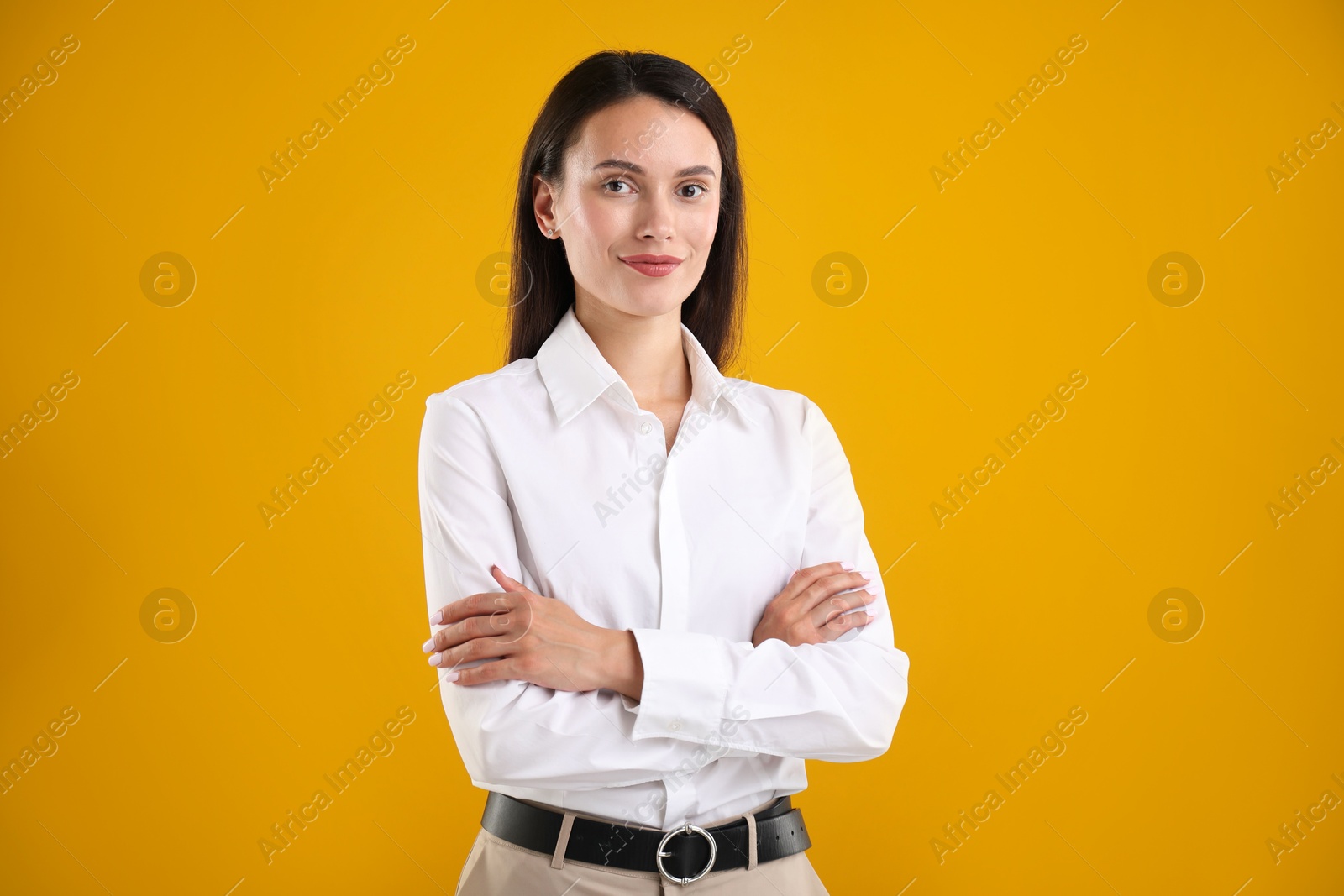 Photo of Portrait of confident businesswoman on yellow background