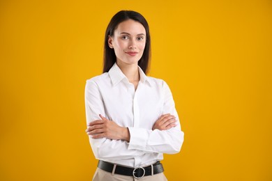 Photo of Portrait of confident businesswoman on yellow background