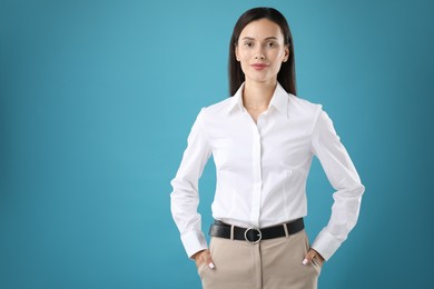 Photo of Portrait of confident businesswoman on blue background. Space for text