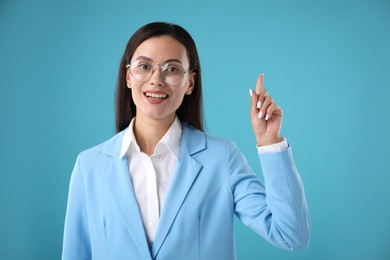 Photo of Confident businesswoman having idea on light blue background