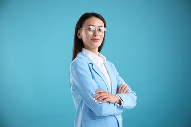 Photo of Portrait of confident businesswoman on light blue background