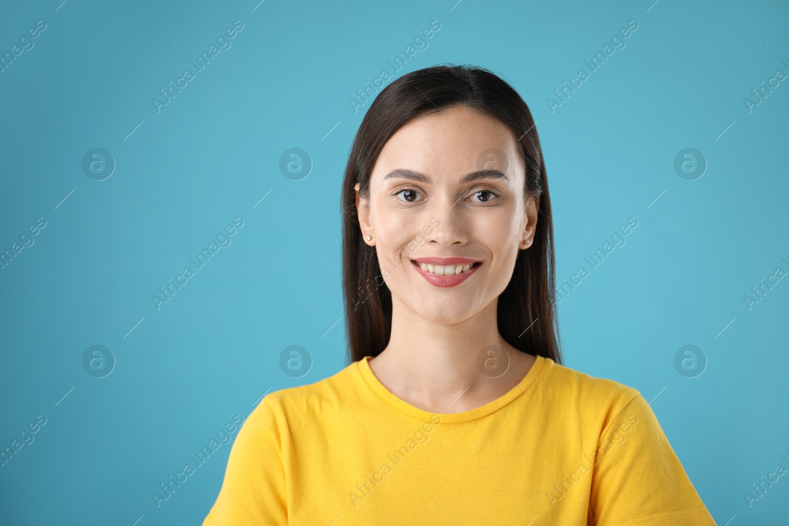 Photo of Portrait of beautiful woman on light blue background