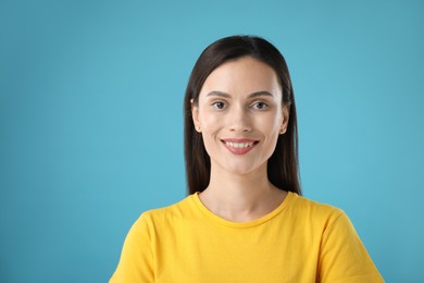 Photo of Portrait of beautiful woman on light blue background