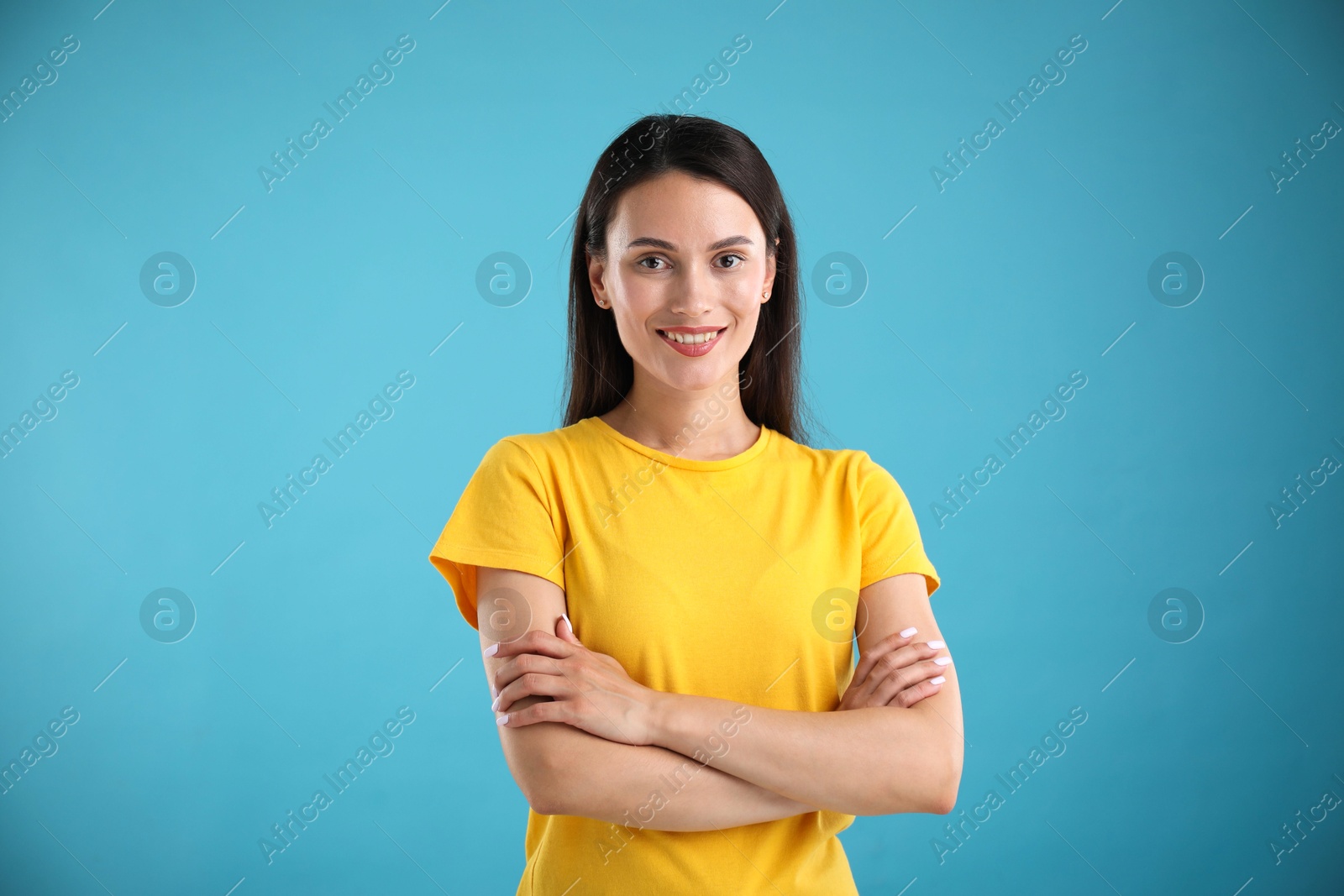 Portrait of beautiful woman on light blue background Photo of Portrait of beautiful woman on light blue background