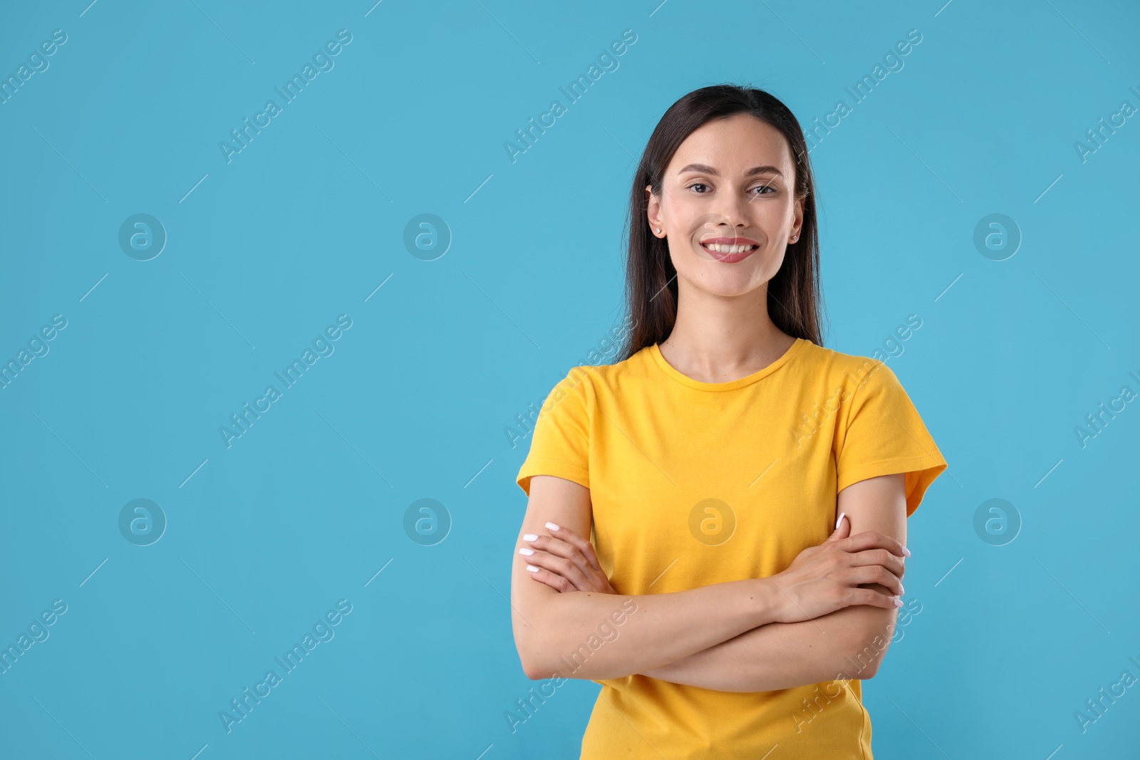 Photo of Portrait of beautiful woman on light blue background. Space for text