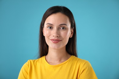 Photo of Portrait of beautiful woman on light blue background