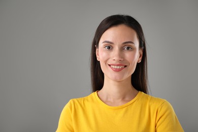 Photo of Portrait of beautiful woman on light grey background. Space for text