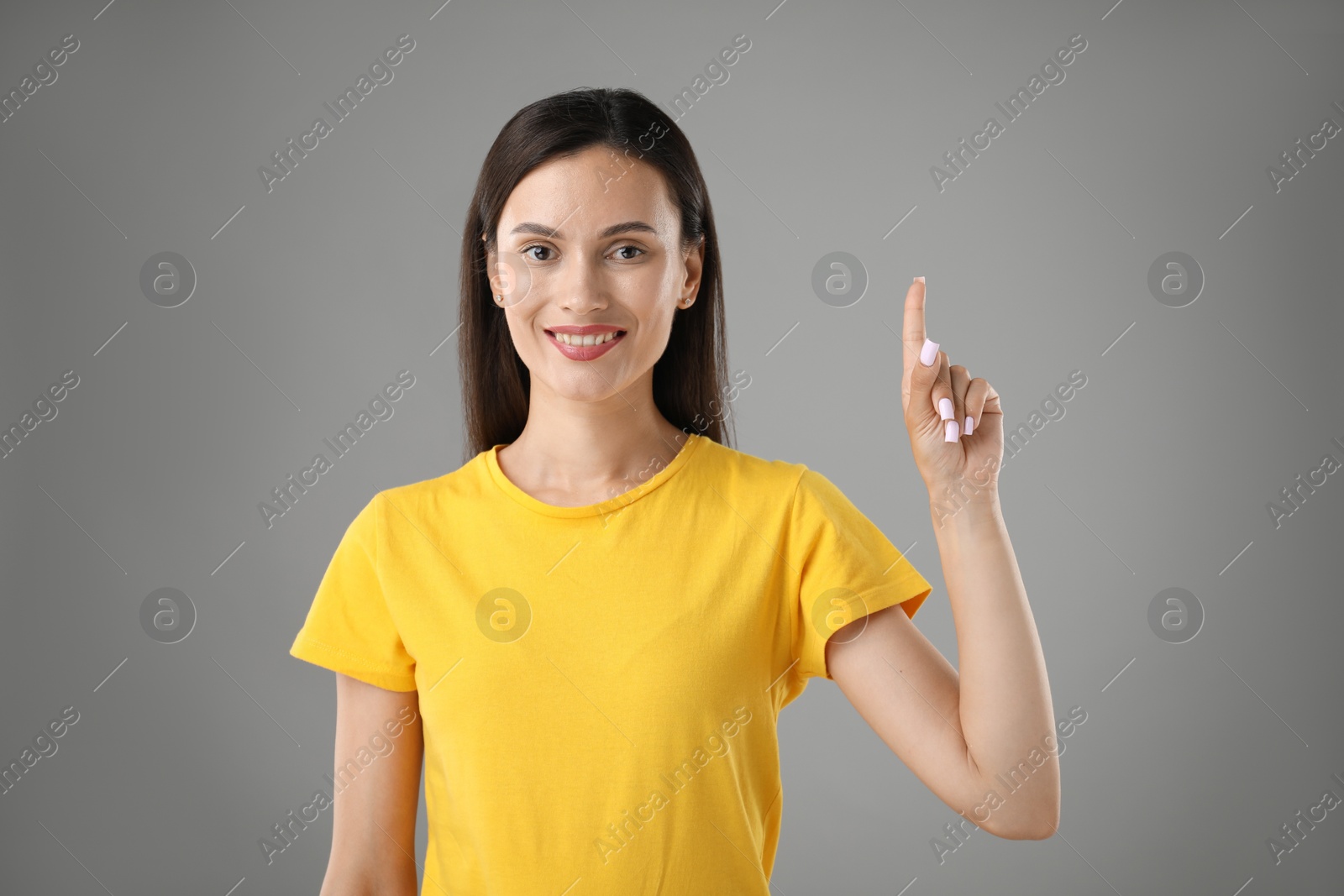 Photo of Beautiful woman having idea on light grey background