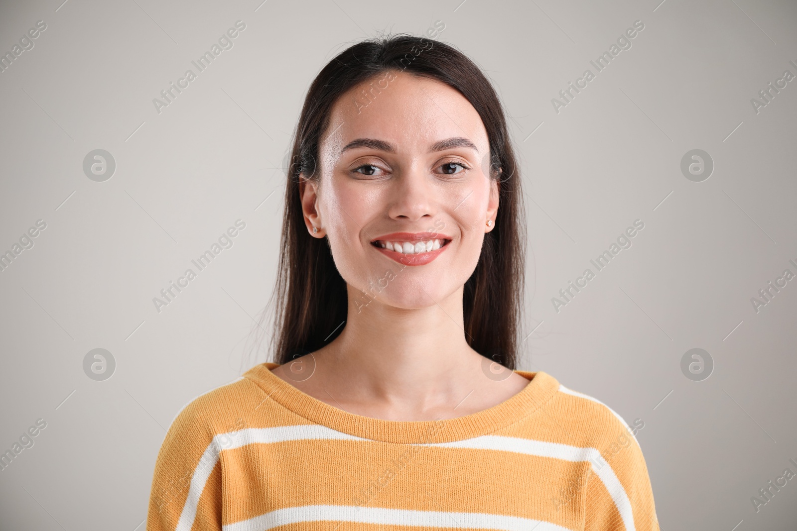 Photo of Portrait of beautiful woman on light background