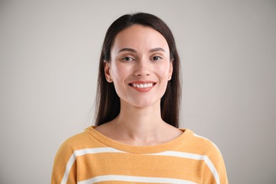 Photo of Portrait of beautiful woman on light background
