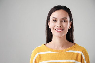 Photo of Portrait of beautiful woman on light background. Space for text