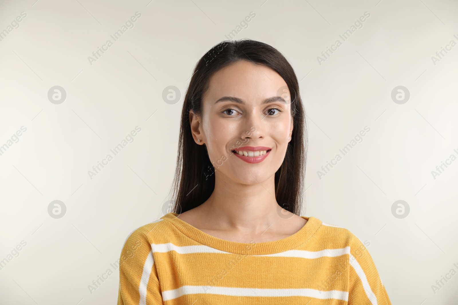 Photo of Portrait of beautiful woman on light background