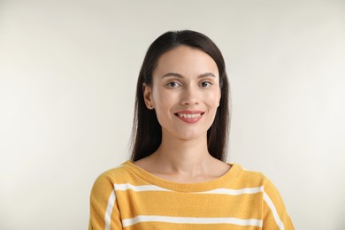 Photo of Portrait of beautiful woman on light background