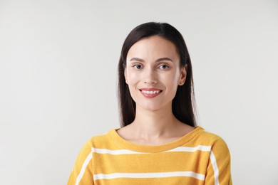 Photo of Portrait of beautiful woman on light background