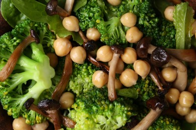 Photo of Delicious salad with shimeji mushrooms, chickpeas and broccoli as background, top view