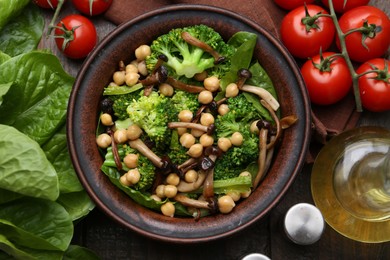Photo of Delicious salad with shimeji mushrooms, chickpeas and broccoli served on wooden table, flat lay